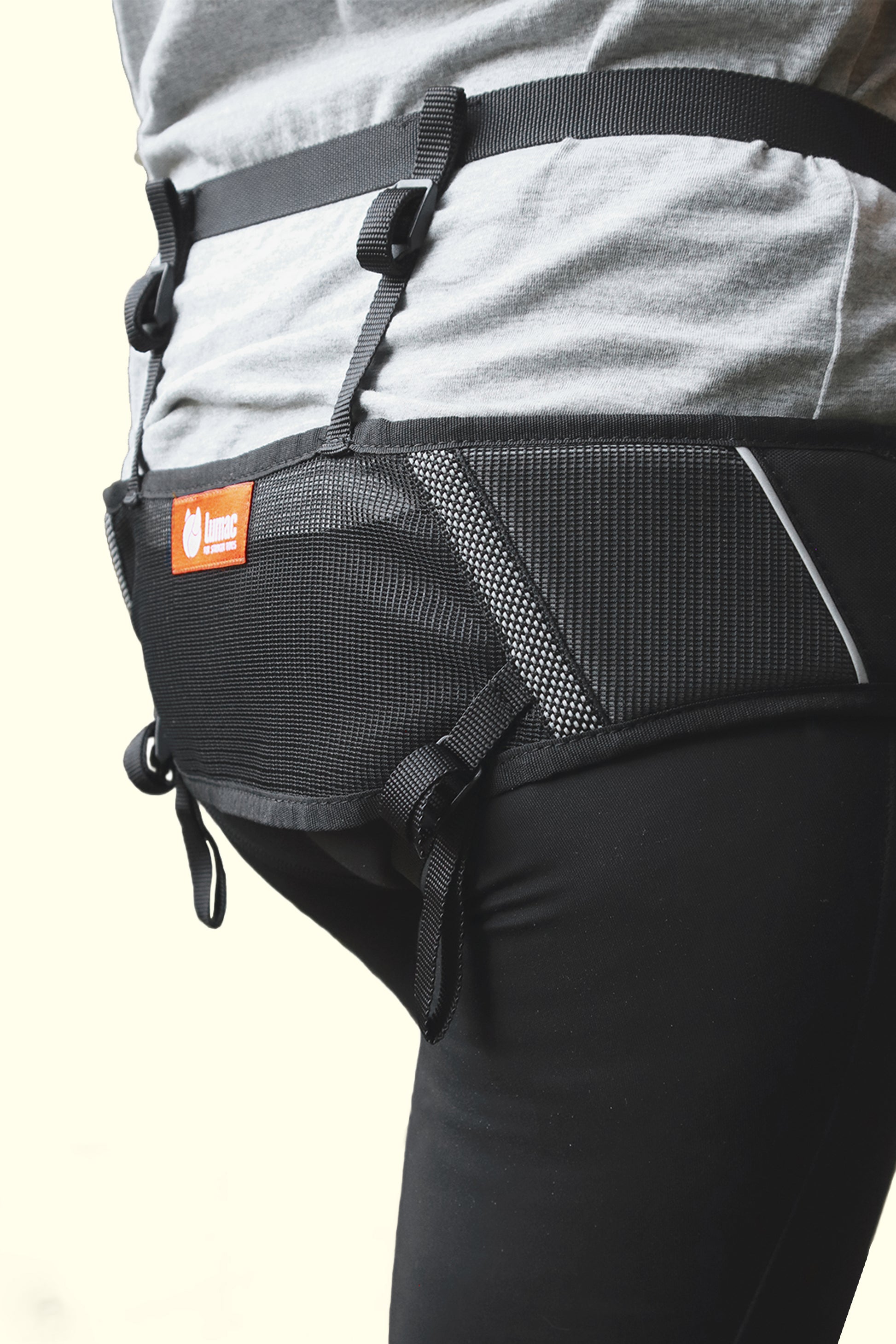 Black belt attached to a person's waist with a visible brand logo on a light background