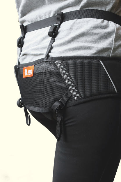 Black belt attached to a person's waist with a visible brand logo on a light background